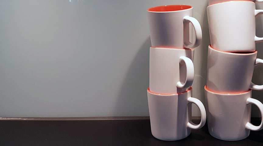 Two stacks of coffee cups at the Zooma office