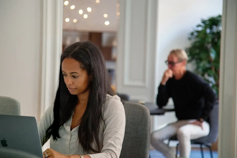 Zooma expert working on a laptop in an office setting.