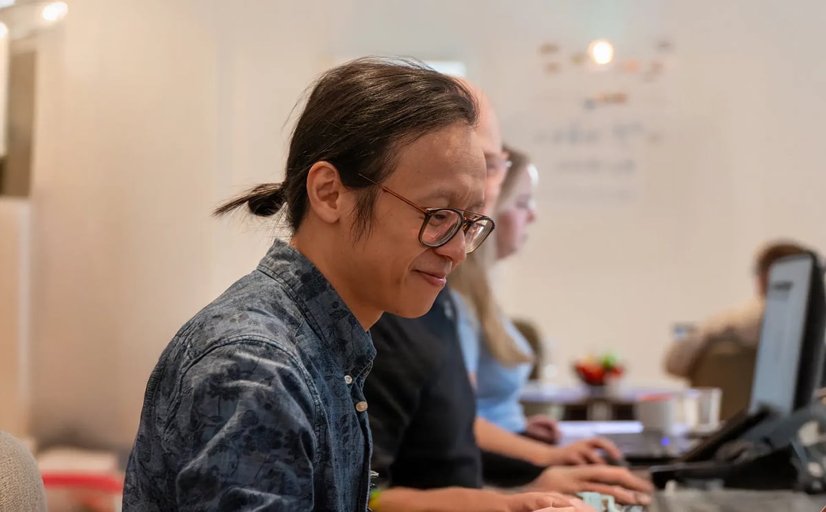 Professional working at desktop computer to implement strategy and drive business results.