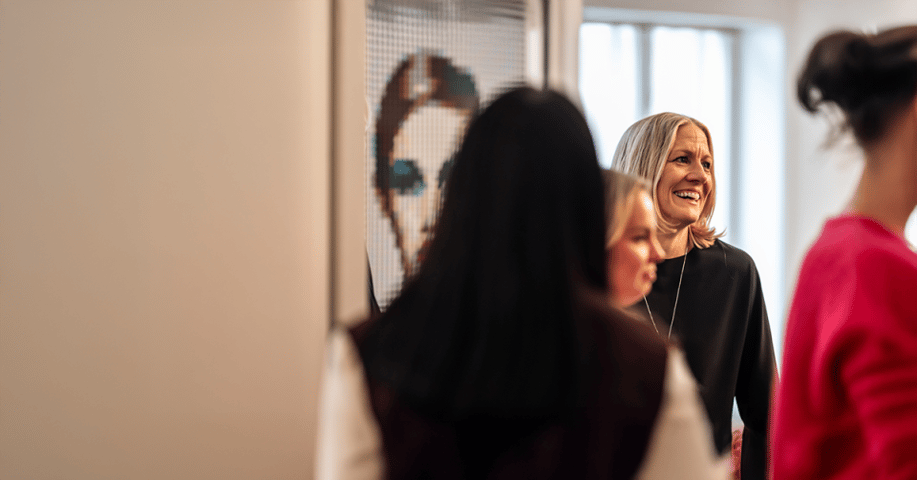 Woman smiling at a social gathering in the office in Gothenburg