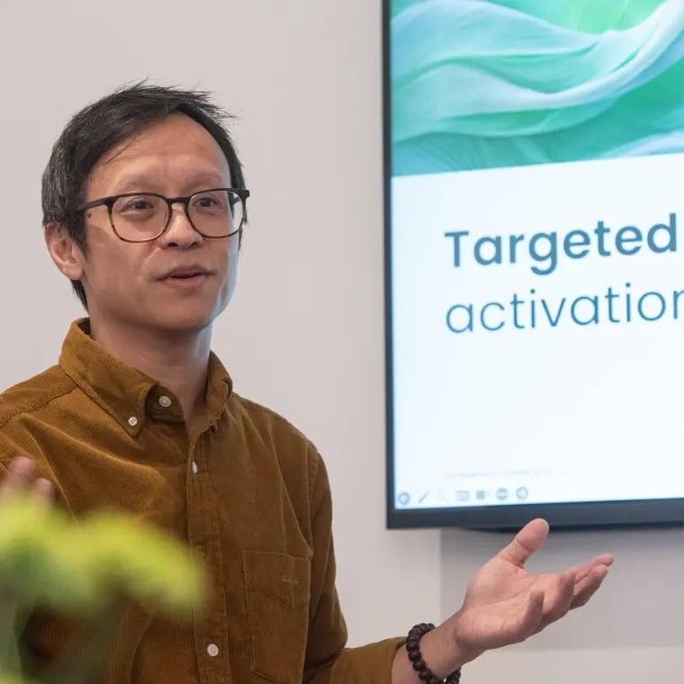 Man giving a presentation next to a screen displaying “Targeted activation.”