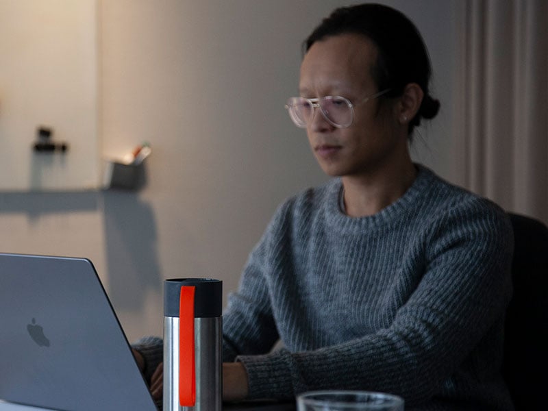 Kang working on a laptop at the Zooma office