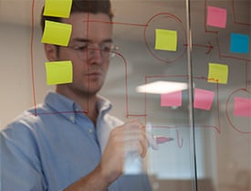 Doug making notes on a glass wall at the Zooma office