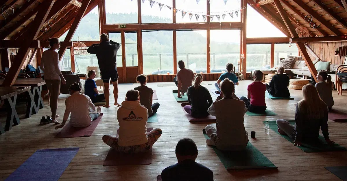 Zooma colleagues taking part in a group yoga session during the team kick-off at Sju Sjöar