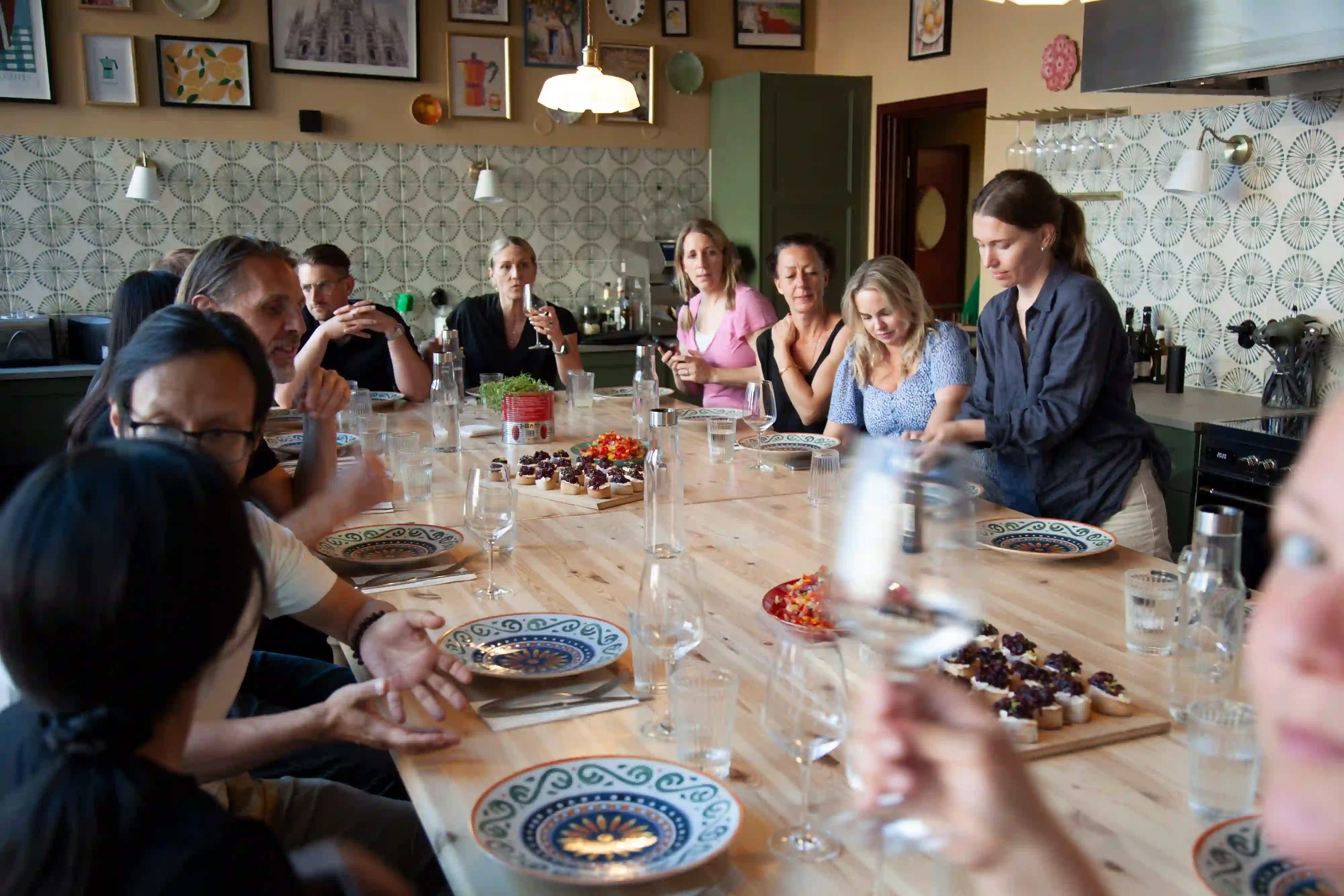Zooma team gathered around the table before enjoying their Italian Summer Fun dinner
