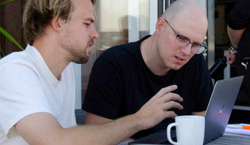 Zooma-Alex-and-Marko-sitting-outside-with-laptop