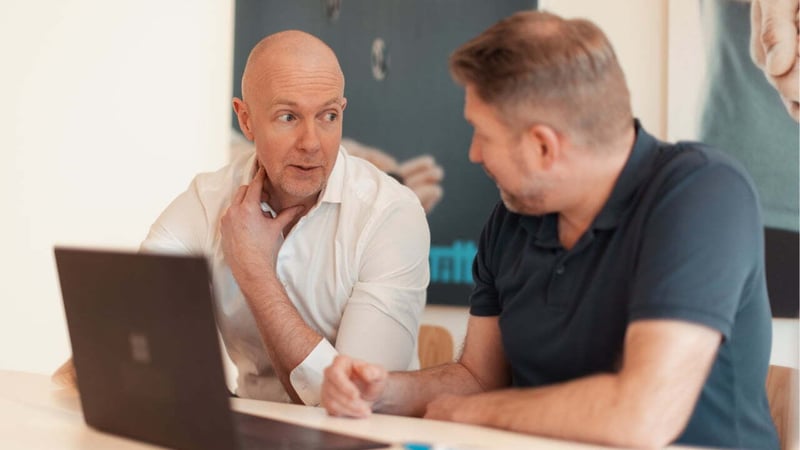 tilka-two-men-working-together-laptop